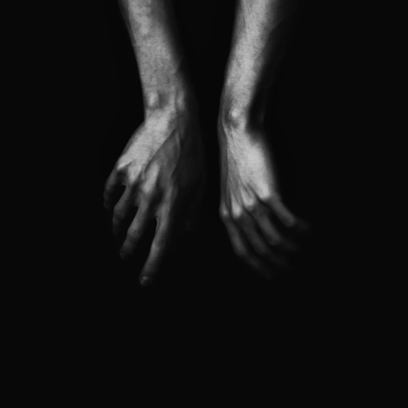 Two hands in low light, an abstract image about intuitive control